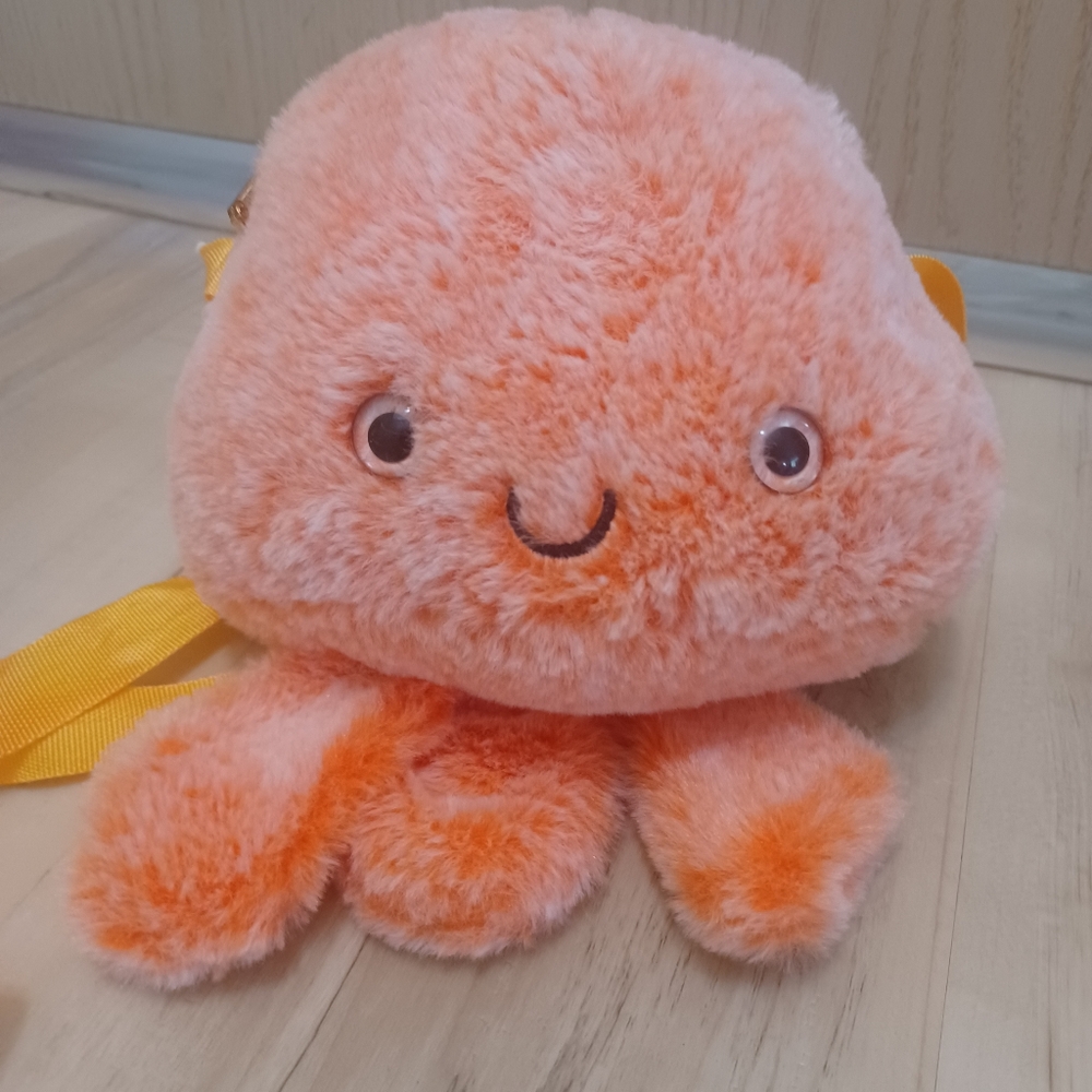 Childrens octopus orange purse with yellow strap.
